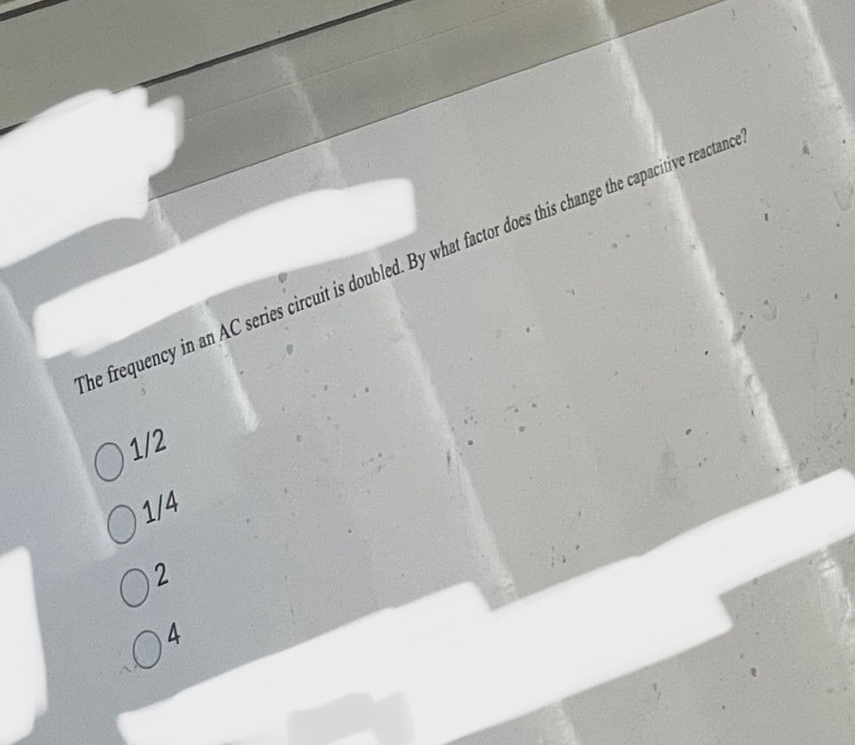 The frequency in an AC series circuit is doubled. By what factor does this change the capacitive reactance?
01/2
1/4
02
04