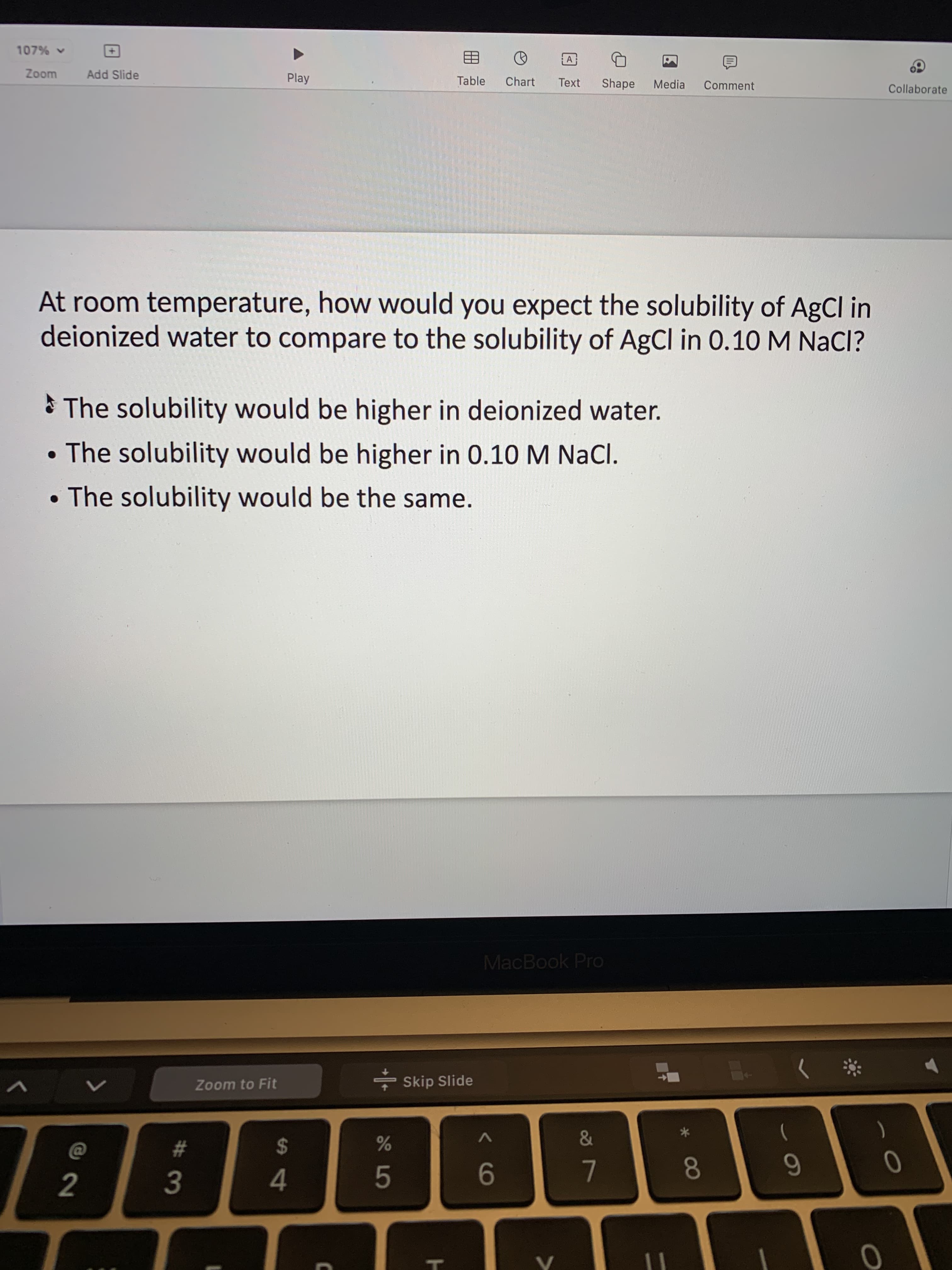 00
T
5
#3
2.
107%
Zoom
Add Slide
Play
Table
Chart
Text
Shape
Media
Comment
Collaborate
At room temperature, how would you expect the solubility of AgCl in
deionized water to compare to the solubility of AgCl in 0.10 M NaCl?
* The solubility would be higher in deionized water.
•The solubility would be higher in 0.10 M NaCl.
• The solubility would be the same.
MacBook Pro
- Skip Slide
Zoom to Fit
&
$
0
4.
9-
