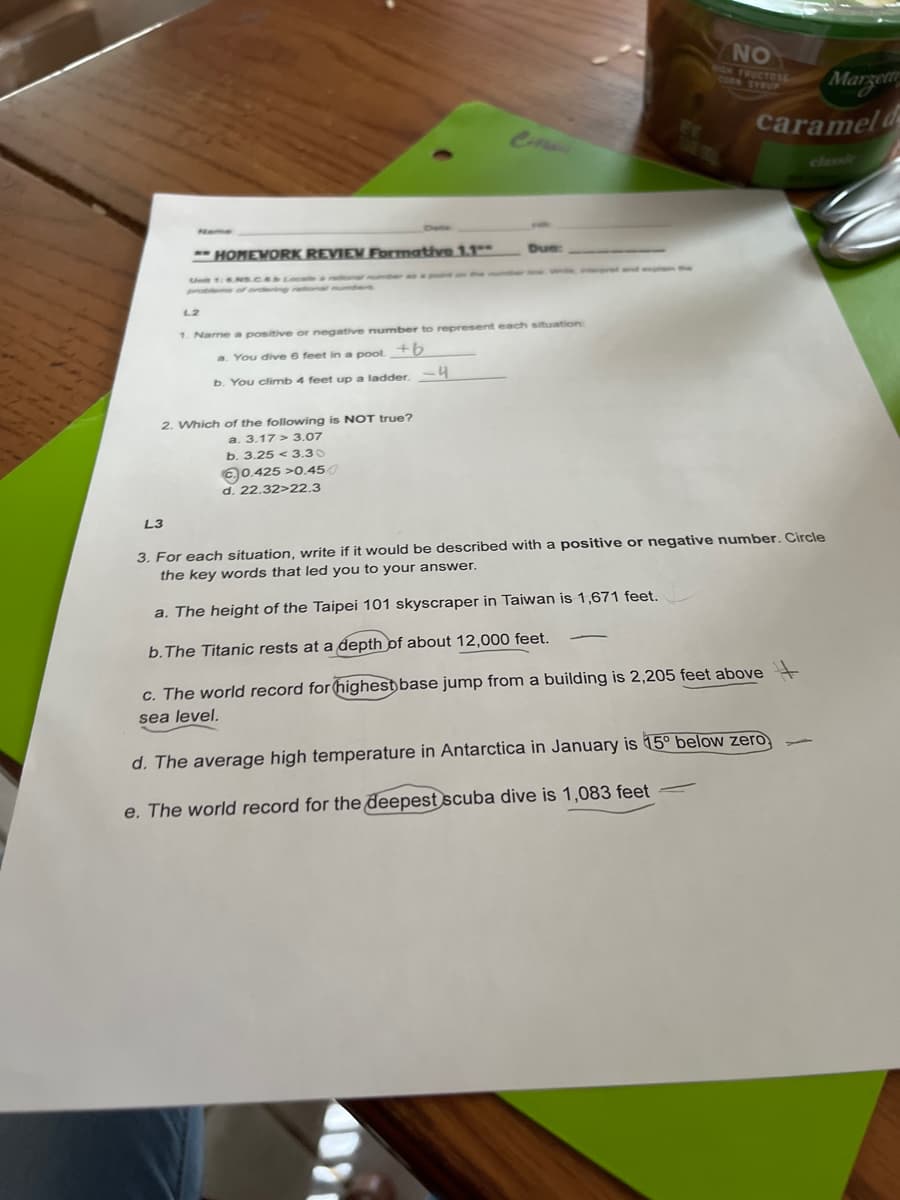 Name
L3
- HOMEWORK REVIEW Formative 1.1
L2
2. Which of the following is NOT true?
a. 3.17 3.07
b. 3.25 3.30
0.425 >0.450
d. 22.32>22.3
Due:
1. Name a positive or negative number to represent each situation:
a. You dive 6 feet in a pool. +b
b. You climb 4 feet up a ladder. -4
NO
GH FRUCTOSE
Marzett
caramel d
3. For each situation, write if it would be described with a positive or negative number. Circle
the key words that led you to your answer.
a. The height of the Taipei 101 skyscraper in Taiwan is 1,671 feet.
b. The Titanic rests at a depth of about 12,000 feet.
c. The world record for highest base jump from a building is 2,205 feet above +
sea level.
d. The average high temperature in Antarctica in January is 15° below zero,
e. The world record for the deepest scuba dive is 1,083 feet